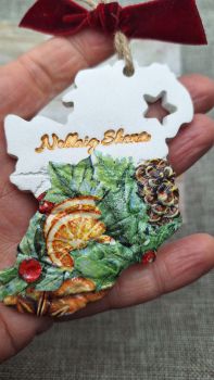 These are my gorgeous map of Ireland &lsquo;Nollaig Shona&rsquo; Christmas decorations. Perfect gift for family and friends celebrating abroad. Handcrafted using air dry clay, stamped, embossed and decoupaged with a beautiful gloss detail &amp; festive ribbon. Indoor use only. Please allow 1 week processing times on top of standard An Post delivery times.