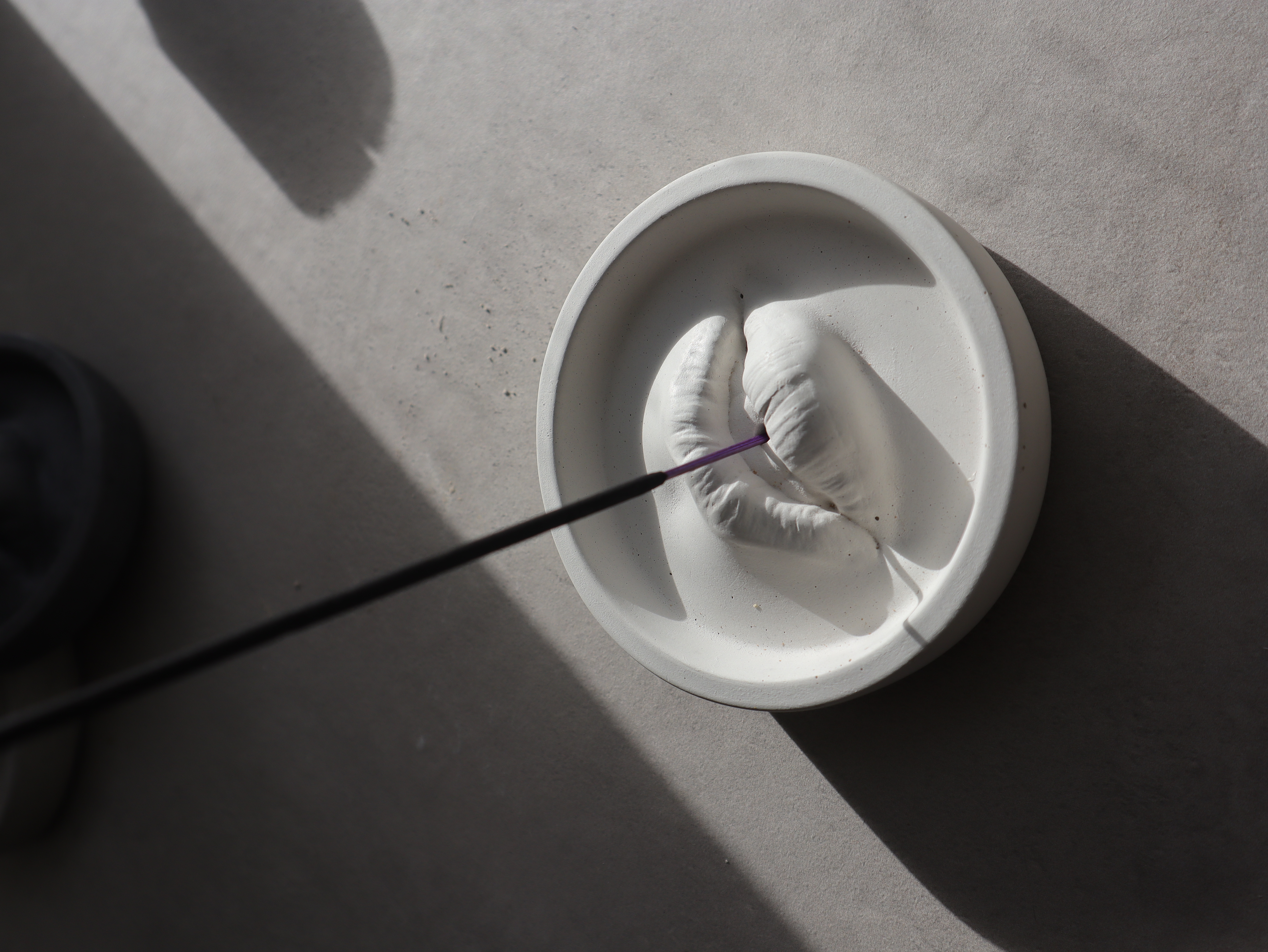 Contemporary concrete insence holder. Comes in white, natural grey or charcoal colours.

Size: 11.5 x 3 cm, weight 0.5kg
Foam padded to protect surfaces from scrathing
Handcrafted from concrete
Suitable for standard incense sticks
