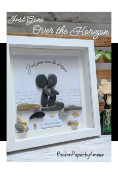 A beautiful piece to remember a much loved family member or friend. Reading &ldquo;Just gone over the horizon&rdquo;, this unique pebble art features two figures looking at the horizon on a stony beach (one meant as the deceased and the other, the person going through the duel).
