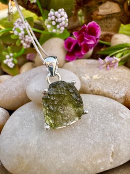 This exquisite Genuine Moldavite Sterling Silver Necklace is handmade, making it a meaningful and special accessory. Known for its healing properties, Moldavite will help you to open up to the spiritual world and bring balance and harmony into your life. The beautiful sterling silver chain and setting will add a touch of elegance to any look.