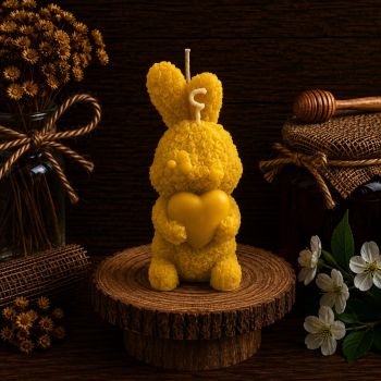 Illuminate your space with our Bunny Holding a Heart Rose Petals Beeswax Candle. Handcrafted, it stands 110mm tall, weighs 115g, and boasts a 15-hour burn time. The symbolic design features a bunny cradling a heart amidst delicate rose petals, adding both beauty and emotion to any setting. &nbsp;