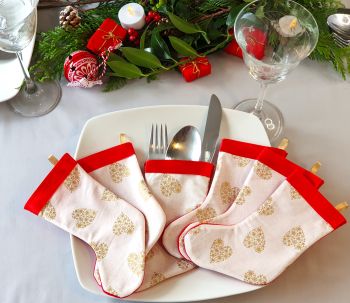 &bull;Decorate your Christmas table with these gold snowflake hearts on cream fabric stockings cutlery holder set. * There is a set of 4 or 6 stockings sets available in this fabric topped with Christmas gold ribbon, backed with red felt. Multiple sets can be ordered at checkout. &bull;Each stocking can be used to hold your dinner cutlery, candy canes, or simply hang on your Christmas tree.&nbsp;
