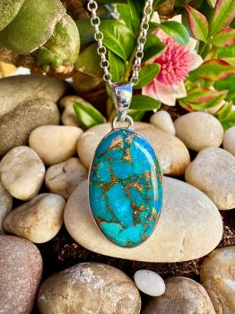 Blue Copper Turquoise Bezel Set Sterling Silver Necklace Metal: Sterling Silver Gem:&nbsp;Blue Copper Turquoise Stone size: 29mm x 12.5mm Birthstone: December Turquoise represents the wisdom that comes from all of life&rsquo;s experiences. It reminds us that wholeness can only come when we are willing to embrace the totality of who we are and what we have learned.