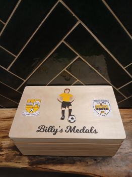 Personalised Soccer Medal box, with two soccer crests. Box is finished with a non toxic wax. The dimensions of the box are 29cm x 18cm x 13cm a very generous size to store all your well earned medals. Choose male and female player, Choose what colour kit, hair and skin colour you would like on the soccer player. Great to make the soccer player look like the recipient of the gift and the colours of their soccer club. The ideal gift for any soccer fanatic with a medal haul and nowhere to store them. Leave them speechless with this personalised medal keepsake box, something they will have to cherish their soccer medals. These personalised soccer medal keepsake boxes are the perfect gift for a birthday, mothers day, fathers day, communion, confirmation or Christmas present. A truly unique gift for any ocassion&nbsp; &nbsp;
&nbsp;
