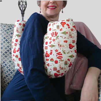 My breast cancer surgery support pillows are ideal for use directly after surgery, or in the following weeks while healing takes place. This support pillow is shaped to fit comfortably under the affected arm, and is filled with high quality polyester filling to a fairly firm finish, perfect to provide adequate support and comfort.&nbsp;
This pillow reaches mid chest in width, so it will easily cover the surgery area. It measures 43cm wide X 37cm long and 10 cm in depth. This Santa&rsquo;s clothes on a cream backing with gold foil detail. This fabric is soft and breathable. All pillows come with a made with love by Rodgerson Handcraft label and are reversible.