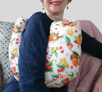 My breast cancer surgery support pillows are ideal for use directly after surgery, or in the following weeks while healing takes place. This support pillow is shaped to fit comfortably under the affected arm, and is filled with high quality polyester filling to a fairly firm finish, perfect to provide adequate support and comfort.
This pillow reaches mid chest in width, so it will easily cover the surgery area, and provide support&nbsp; and padding.
It measures 43cm wide X 37cm long and 10 cm in depth. This has cute robins, candy canes, holly leaves themed fabric. It is soft and breathable. All cushions come with a made with love by Rodgerson Handcraft label and are reversible.