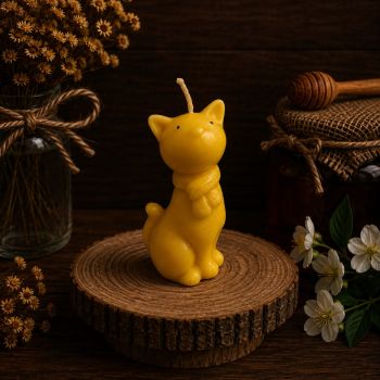 Meet our adorable Cat Beeswax Candle, a whimsical creation made from our own pure beeswax. Standing at 110mm in height, 55mm wide, and weighing 81g, this charming feline candle is a delightful addition to your home decor. Not only does the Cat Beeswax Candle showcase exquisite craftsmanship, but it also offers a lengthy burn time of up to 20 hours. Sourced from our own hives, the beeswax used ensures a clean and eco-friendly candle, perfect for those who appreciate sustainable living. Whether you&rsquo;re a cat lover or looking for a unique gift, this candle adds a touch of warmth and playfulness to any space. Embrace the enchantment of our Cat Beeswax Candle, where artistry meets sustainability.