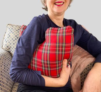 My breast cancer surgery support pillows are ideal for use directly after surgery, or in the following weeks while healing takes place. This support pillow is shaped to fit comfortably under the affected arm, and is filled with high quality polyester filling to a fairly firm finish, perfect to provide adequate support and comfort.
This pillow reaches mid chest in width, so it will easily cover the surgery area, and provide support and padding. It measures 43cm wide X 37cm long and 10 cm in depth. This red check tartan fabric is soft and breathable. All cushions come with a made with love by Rodgerson Handcraft label and are reversible.