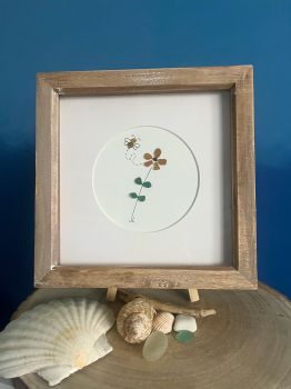 Bee and sunflower.&nbsp; &nbsp;Made from naturally geniune tumbled seaglass collected by me and my family&nbsp; from Seaham beach. wooden frame 7 inches X 7 Inches
