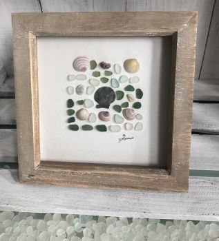 Seashells and Seaglass.&nbsp; &nbsp;Made from tumbled seaglass collected by me and my family from Seaham beach, shells from Ireland. wooden frame 7 inches X 7 Inches