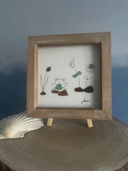 Frog in the garden.&nbsp; &nbsp;Made from naturally geniune tumbled seaglass collected by me and my family&nbsp; from Italy. wooden frame 7 inches X 7 Inches