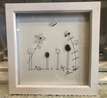Family and flowers.&nbsp; Made from geniune tumbled seaglass collected by me and my family from Seaham beach.&nbsp; &nbsp;White frame 9 inches X 9 Inches.&nbsp;