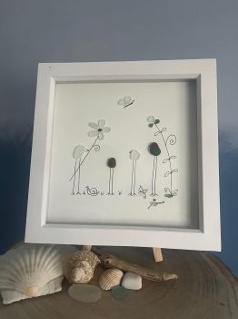 Family and flowers.&nbsp; Made from geniune tumbled seaglass collected by me and my family from Seaham beach.&nbsp; &nbsp;White frame 9 inches X 9 Inches.&nbsp;