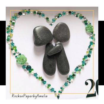 If all wedding anniversaries are important, the emerald wedding anniversary has a special symbolism. It is the symbol of 20 years of life together! This mark means you've withstood trials and kept the flame of your love intact.
This piece features a couple embracing inside a heart made with dainty little jewels in different emerald tones.Made to order only, this pebble art picture can be personalised to include the couple's names and anniversary date.This picture comes on a wooden frame of approximately 10x10 inches. It can be wall hanged or rested on a table.