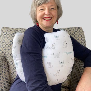 My breast cancer surgery support pillows are ideal for use directly after surgery, or in the following weeks while healing takes place. This support pillow is shaped to fit comfortably under the affected arm, and is filled with high quality polyester filling to a fairly firm finish, perfect to provide adequate support and comfort.
This pillow reaches mid chest in width, so it will easily cover the surgery area, and provide support&nbsp; and padding.
It measures 43cm wide X 37cm long and 10 cm in depth. This lots of dogs drawings print on white fabric is soft and breathable. All pillows come with a made with love by Rodgerson Handcraft label and are reversible.