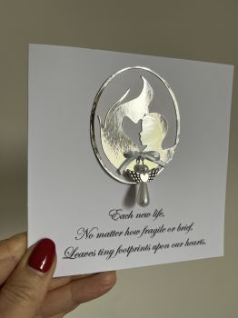 Touching Keepsake Card for Baby Loss
It can be difficult to find the right words during such a heartbreaking time, but this card is a thoughtful way to let someone know you're thinking of them.

Heartfelt Message:&nbsp;Designed to offer comfort and support.
Angel Trinket:&nbsp;A delicate angel charm included as a keepsake to offer a sense of peace and remembrance.
A Card to Cherish:&nbsp;A meaningful card to let them know you care and are there for them, with a token they can keep as a remembrance.

A beautiful way to express sympathy and provide a bit of solace during an incredibly difficult time.