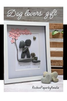Embrace the beauty of love and nature with this bespoke pebble art for a couple and one dog.
This enchanting pebble art piece portrays a couple, arms wrapped around each other, standing beneath a tree. Their loyal dog sits by their side, a silent witness to their enduring bond.&nbsp;
A heartfelt creation that captures the essence of love, nature, and companionship. Handcrafted in Ireland, each piece is as unique as the love story it represents.
Perfect for engagements, weddings, anniversaries, housewarmings and long-distance loved ones.