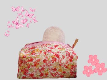 This sanitary pads holder bag has pink, red, yellows abstract flowered print. It is lined with a soft pink fabric and has a soft pink blue zip to close.&nbsp;&nbsp;
This bag will fit standard period pads or tampons packets. The bag measures 24cm long X 24cm wide with a handmade tag added. It is a descreet way of holding pads or make up, if needed or can&nbsp; be used for everyday uses.&nbsp;&nbsp;