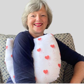 * This Breast cancer surgery support pillow is ideal for use directly after surgery, or in the following weeks while healing takes place. * This support cushion is shaped to fit comfortably under the affected arm, and is filled with quality polyester filling to a firm finish, provide adequate support and comfort
I am a breast cancer survivor myself so I understand what is needed after having had chest surgery, and how important comfort and support is when you're healing.
It measures 43cm wide X 37cm long and 10 cm in depth. This red love hearts balloons and white clouds cotton fabric is soft and breathable. All cushions come with a made with love by Rodgerson Handcraft label and are reversible.