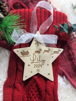 Add a rustic touch to your Christmas tree with our handmade, engraved wooden signs. Available in round, star, or heart shapes, each piece is personalized with a name and "2024" (optional). Crafted from birch plywood, these ornaments come with a white organza ribbon, making them a perfect keepsake or thoughtful gift.