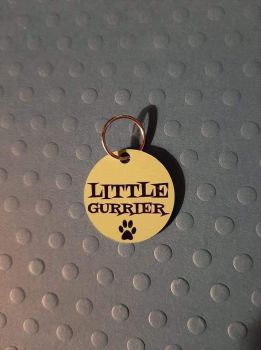 Little gurrier metal dog tag with personal details on reverse.