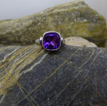 A 9X9mm cushion shaped Amethyst showing a deep purple colour is set in an Irish handmade 9ct. white gold ring. It is currently an American size 6.5 or Irish size N. We will size the ring to fit. Additional costs will apply for larger sizes for the gold added. Sizing will delay shipping up to 1 week.

If this item is shipped outside of the EU, we will happily refund the Irish Sales Tax (VAT) which is quite a savings!